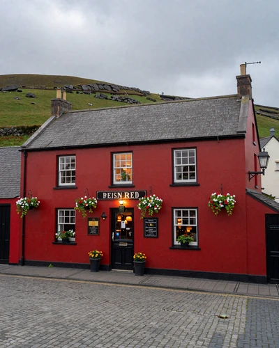 Traditional Irish countryside pub with colorful facade and flower baskets