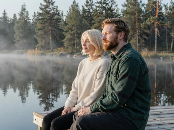Eric and Aino, an American-Finnish couple by a serene Finnish lake