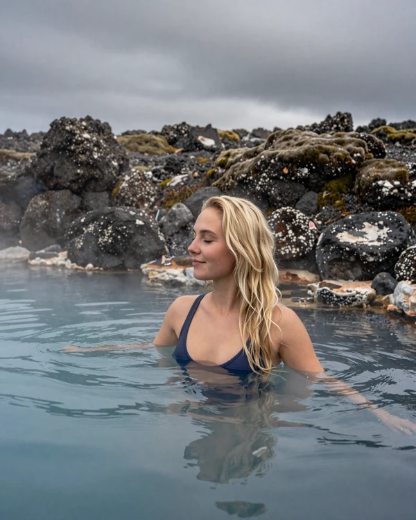Icelandic woman enjoying a natural geothermal hot spring in the Icelandic highlands